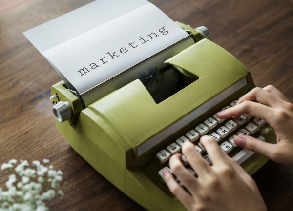 Person Typing on Green Typewrite
